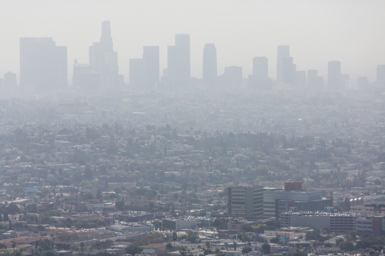 Wide shot of the downtown Los Angeles skyline bathed in smog