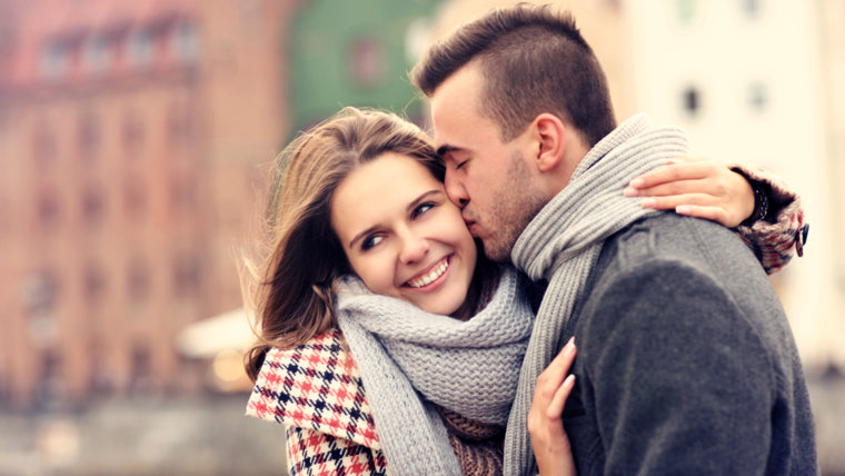 A picture of a man kissing a woman on a date