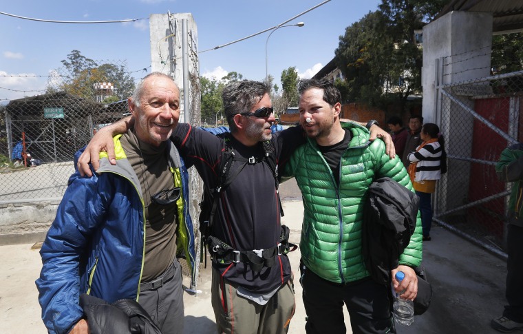 Image: U.S. citizen Michael Churton, 38, right, from New York city, who was injured in an avalanche, set off by the massive earthquake that struck Nepal, bids good-bye to fellow climbers U.S. citizen Mariusz Malkowski from New Jersey, centre, and Ron Niss