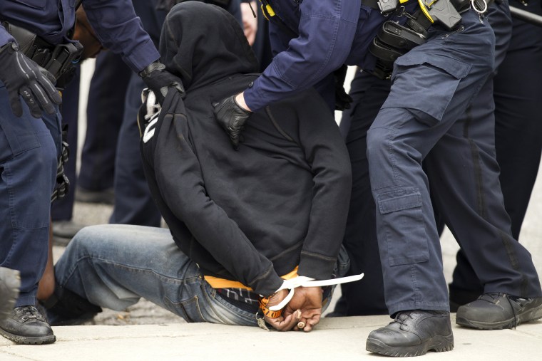 Image:Baltimore police officer sprays pepper spry to demonstrators after the funeral of Freddie Gray