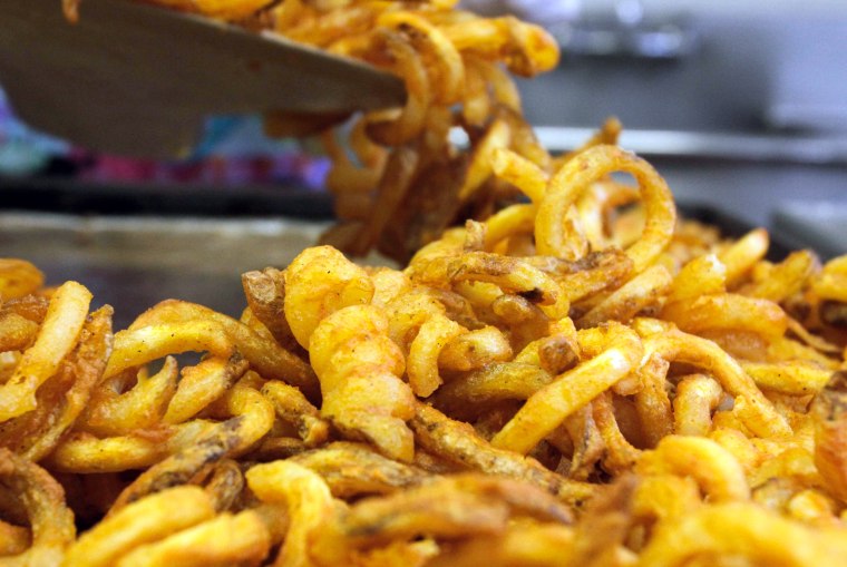 Image:  fresh fries are scooped into containers