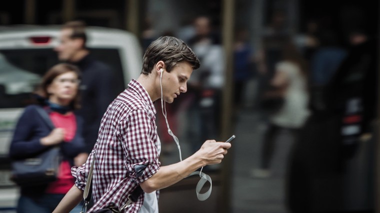 A pedestrian appears distracted by his cell phone in this image released by Lausanne police as part of their campaign to make Swiss aware of the dangers posed by personal electronic devices.