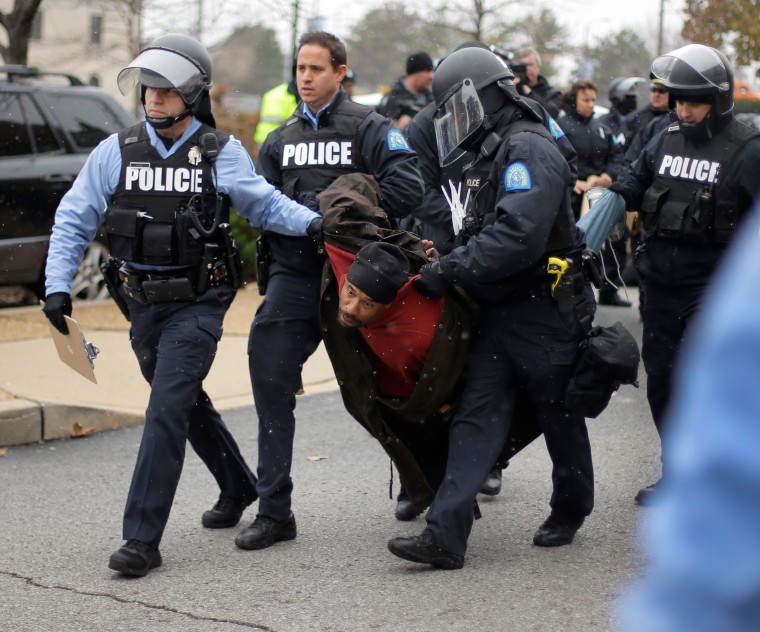 A protester is arrested outside of the St. Louis city hall Wednesday during riots over a grand jury's decision not to indict police officer Darren Wilson in the fatal shooting of Michael Brown, on Nov. 26, 2014.