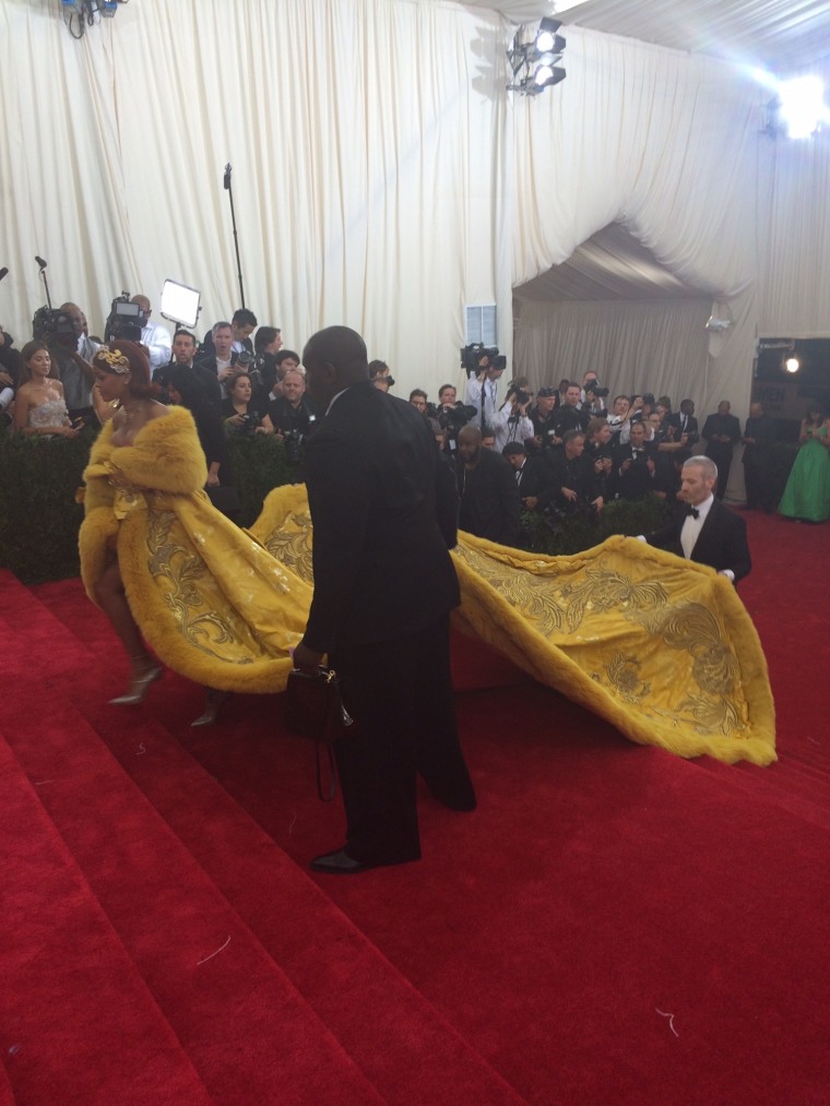 Rihanna and her three handlers. Yes, three men to help her carry that enormous (and glamorous) train!