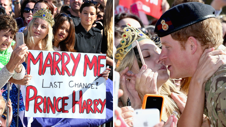 Prince Harry is grabbed by a well-wisher in Sydney who tries to kiss him
