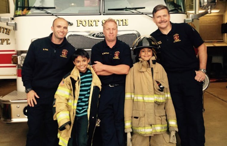 Timmy and his brother with firefighters