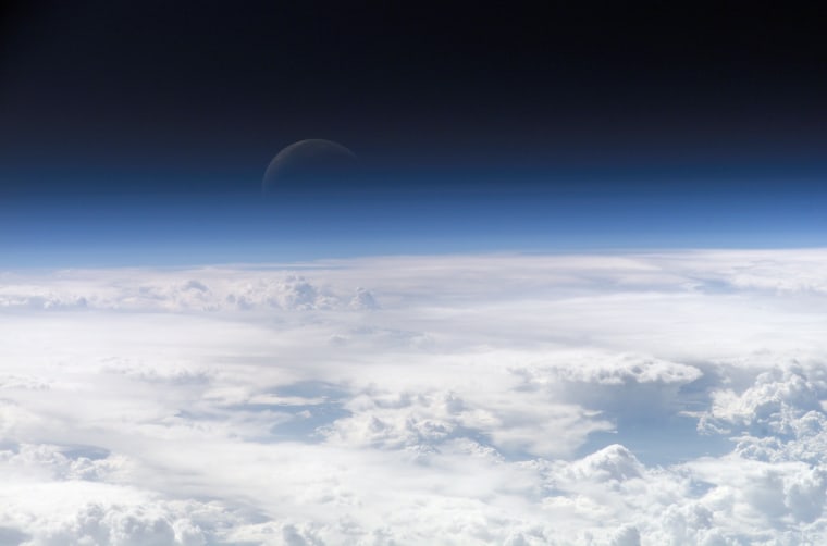 Earth's Moon visible in the horizon