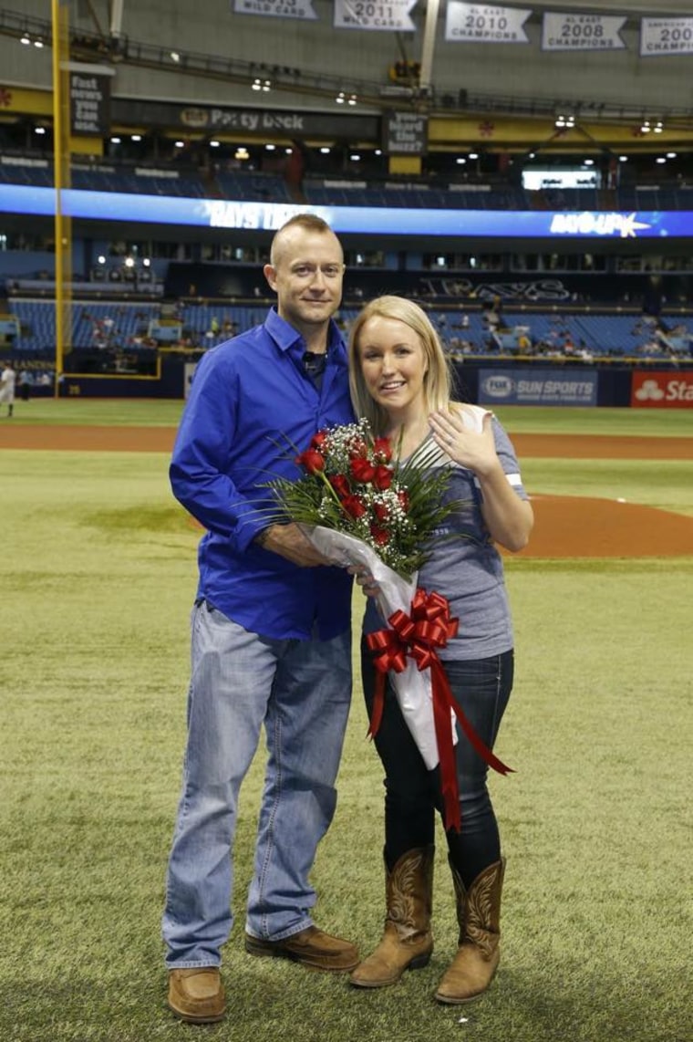 Cameron Hill and Melissa Dohme on the field after the proposal.