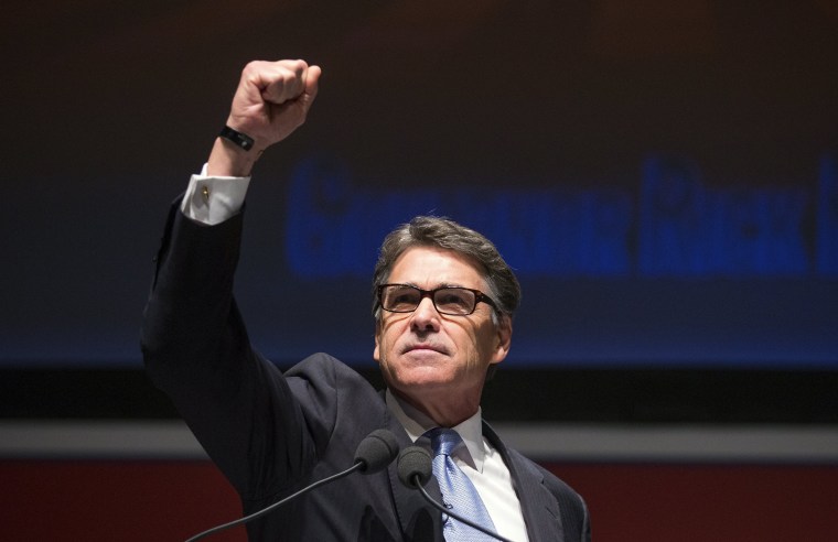 Image: Former Republican Governor of Texas Rick Perry raises his right fist as he speaks at the Freedom Summit in Greenville, South Carolina