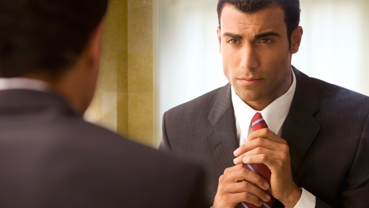 Businessman adjusting his red tie