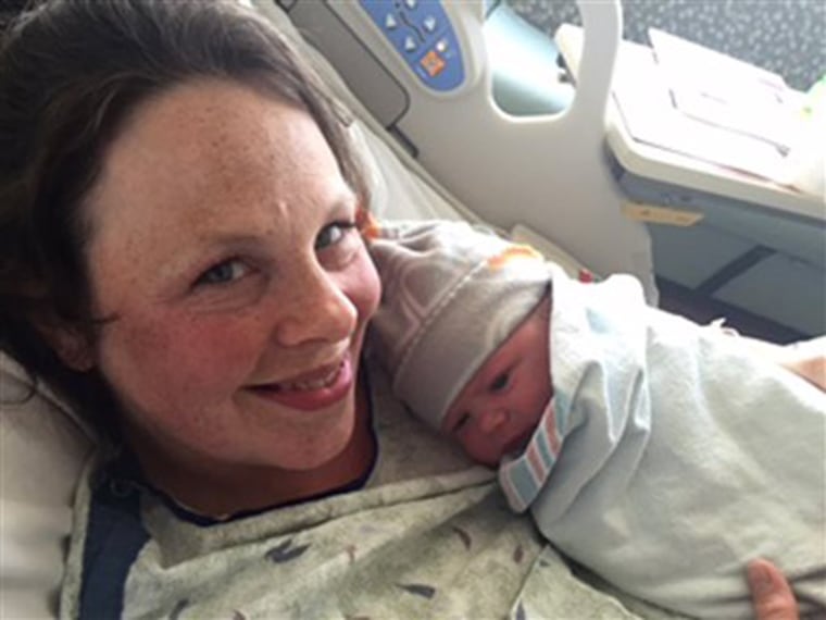 Kateri Schwandt holds her 13th son on May 13, 2015