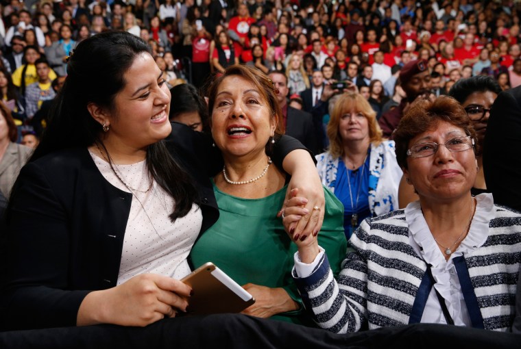 Image: Lorella Praeli, Chela Praeli and Ligia Jimenez (L-R) listen to U.S. President Barack Obama speak about immigration reform