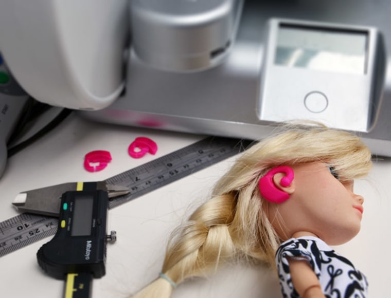 A Makies doll being fitted for a hearing aid.