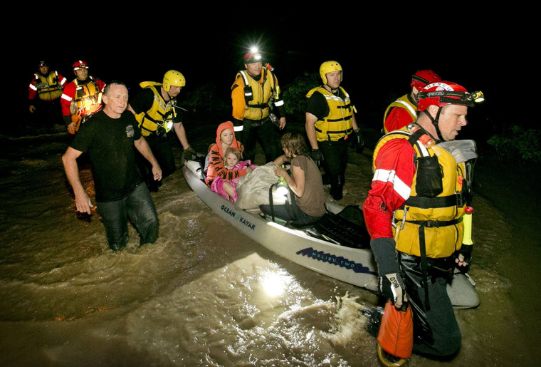 Image: Local residents are rescued by firefighters during flooding in Kyle, Texas