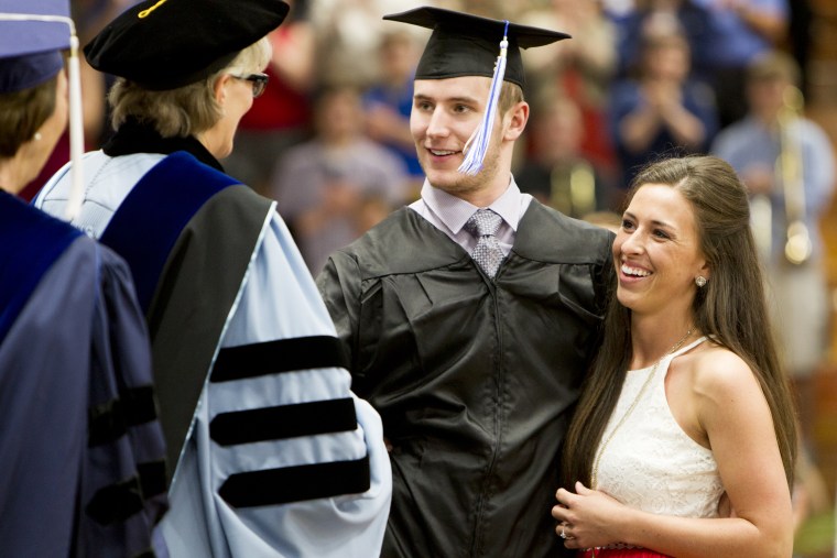 Chris Norton walks across the stage to collect his diploma.