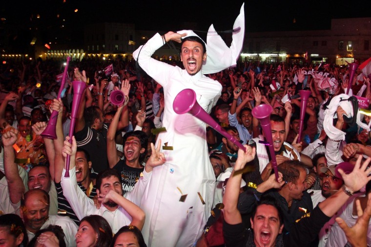 Image: Qatari fans celebrate after being awarded 2022 World Cup