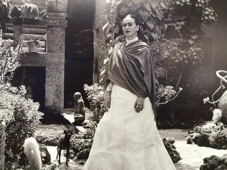 Frida Kahlo poses in her beloved Casa Azul in Mexico. The photo is part of The New York Botanical Garden exhibit "Frida Kahlo: Art, Garden, Life."