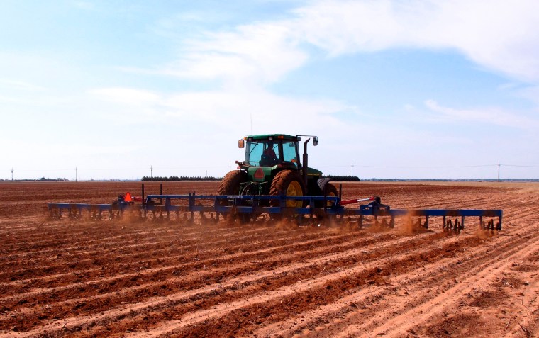 Image: a West Texas cotton grower tills a field north of Lubbock, Texas