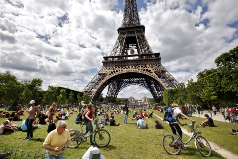 Image: Tourists near the Eiffel Tower in Paris on May 24