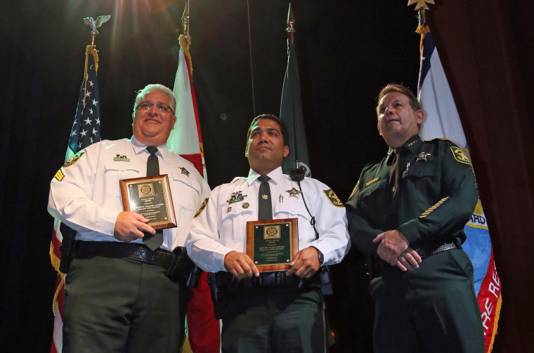 Gold Cross Award winners, from left,  Sgt. Richard LaCerra  and Deputy Peter Peraza stand with Sheriff Scott Israel during the Broward Sheriff’s Office Awards Ceremony at the African-American Research Library in Fort Lauderdale in 2013.
