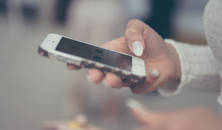 A woman texting on her touchscreen phone