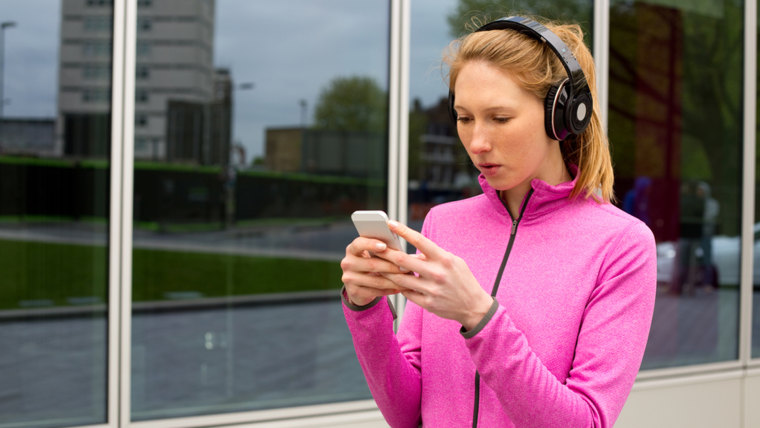 A woman texting on her touchscreen phone