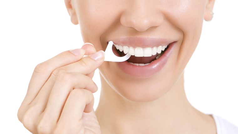 Woman and teeth floss