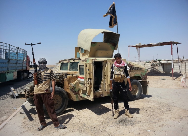 Image: ISIS militants with a captured Humvee in Iraq on June 19, 2014