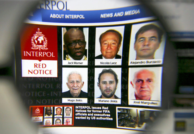 Image: The homepage of the Interpol website is seen through a magnifying glass in this picture illustration taken in Berlin