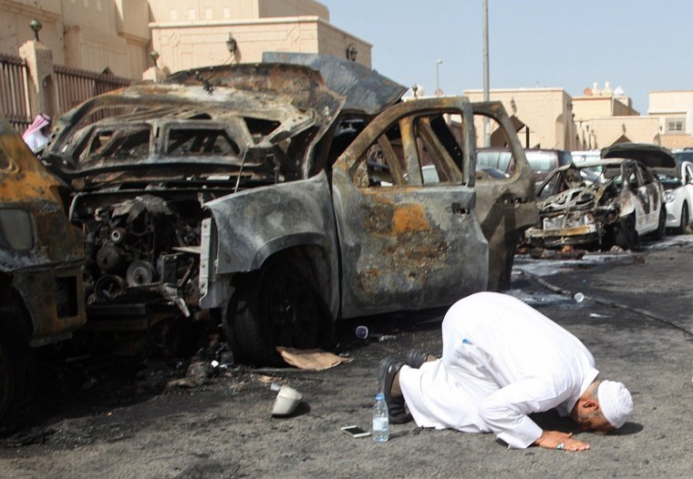 Image: Victim's cousin prays after mosque bombing in Saudi Arabia on May 29