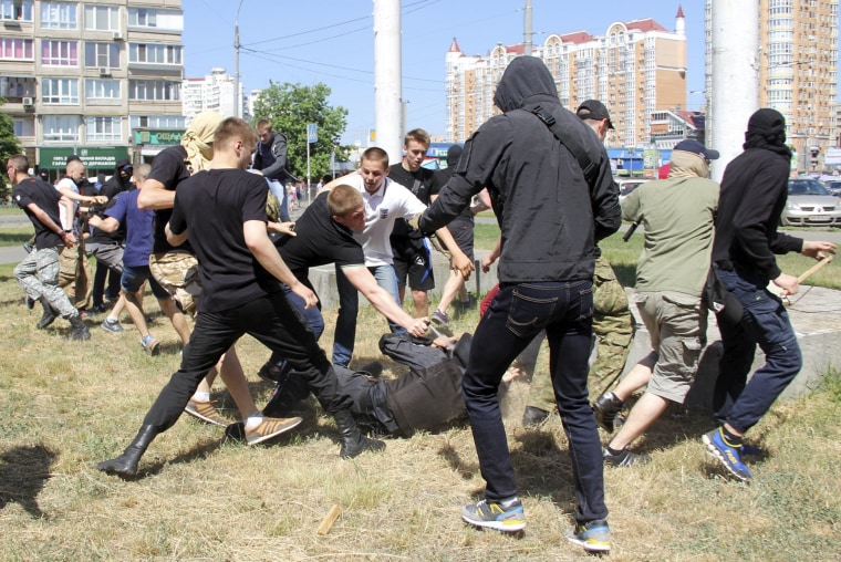 Image: Anti-gay protesters attack a policeman during a march organized by LGBT community in Kiev