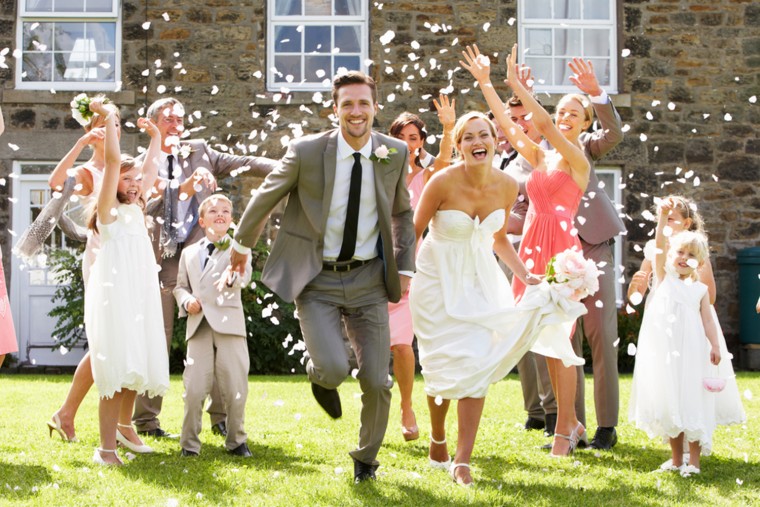 Guests Throwing Confetti Over Bride And Groom.