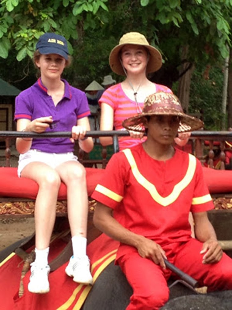 The Millikens ride an elephant in Thailand.