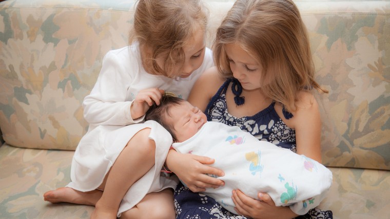Two of Canning's daughters welcome their newest sister.