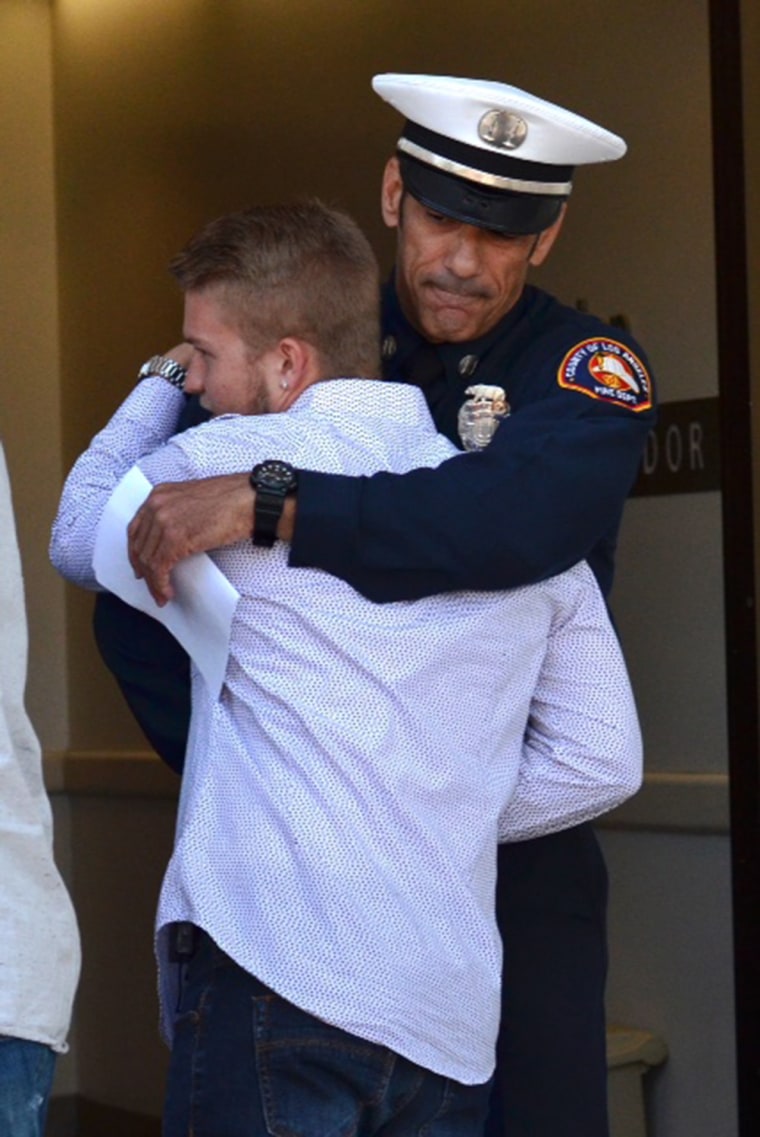 Matt Scalise gets a hug from Captain John Rossi of the Los Angeles County Fire Department