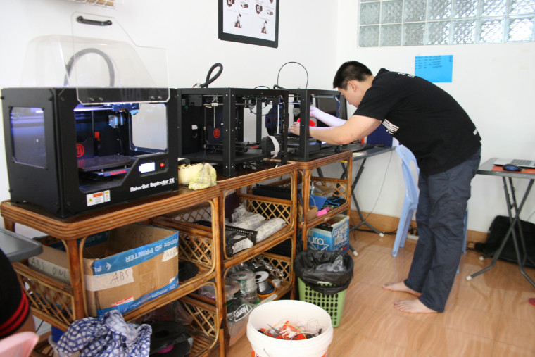 KiHow Tran uses a 3D printer.