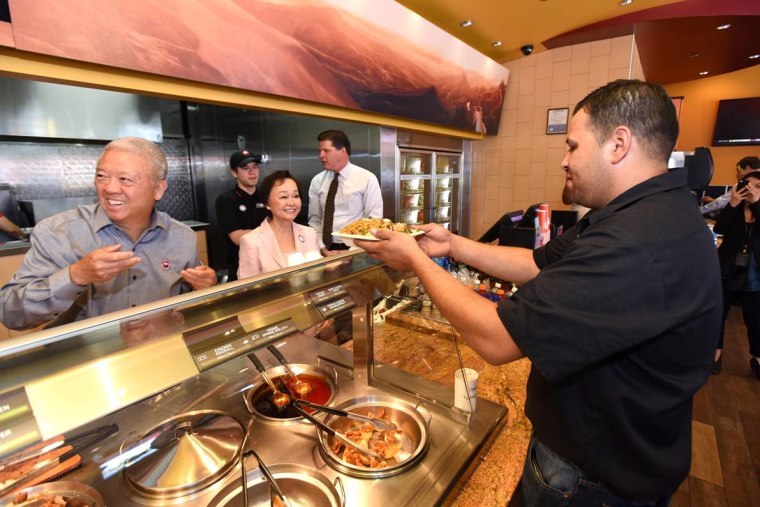 Andrew and Peggy Cherng serving a guest who came in to support Family Day, a Panda Express initiative launched in partnership with 150 local food banks to fight hunger. "Our family has always believed that good fortune is meant to be shared,” said Peggy Cherng.