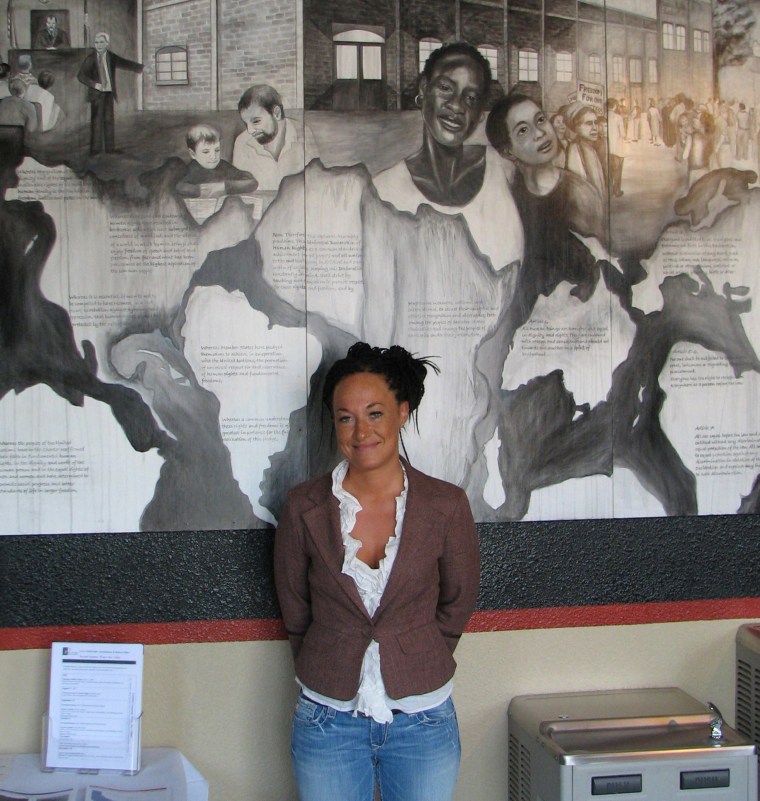 Image: Rachel Dolezal, a leader of the Human Rights Education Institute, stands in front of a mural she painted