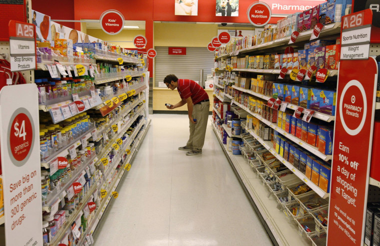Image: A Target store team member places an item back on the shelf at a Target store in Los Angeles