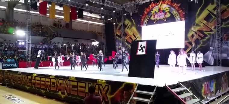 A group of teenage girls wearing Nazi uniforms and swastika flags took the stage at a Mexican Cheerleading Competition. 