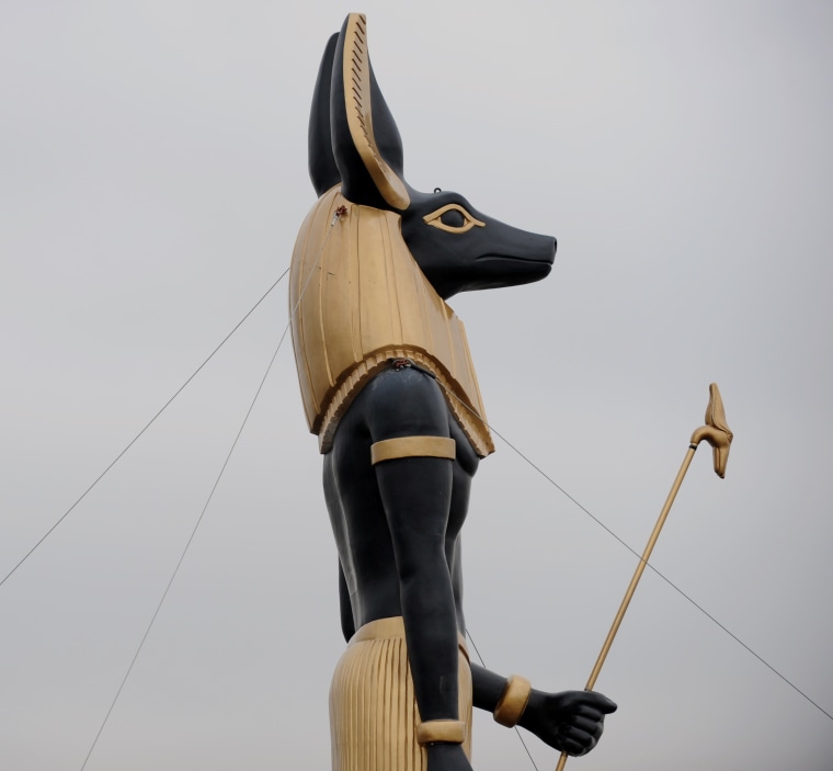 A 25-foot-tall, 7-ton replica of the Egyptian god Anubis travels by barge in New York harbor to publicize an exhibition. Archaeologists say millions of dogs were sacrificed and mummified as a tribute to Anubis, who was traditionally depicted with the head of a dog.