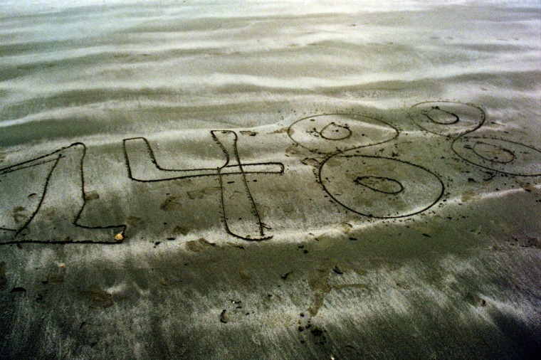 "1488," a numerical symbol popular with white supremacists, is carved in the sand in a photo posted to a website registered under the name of Dylann Roof.