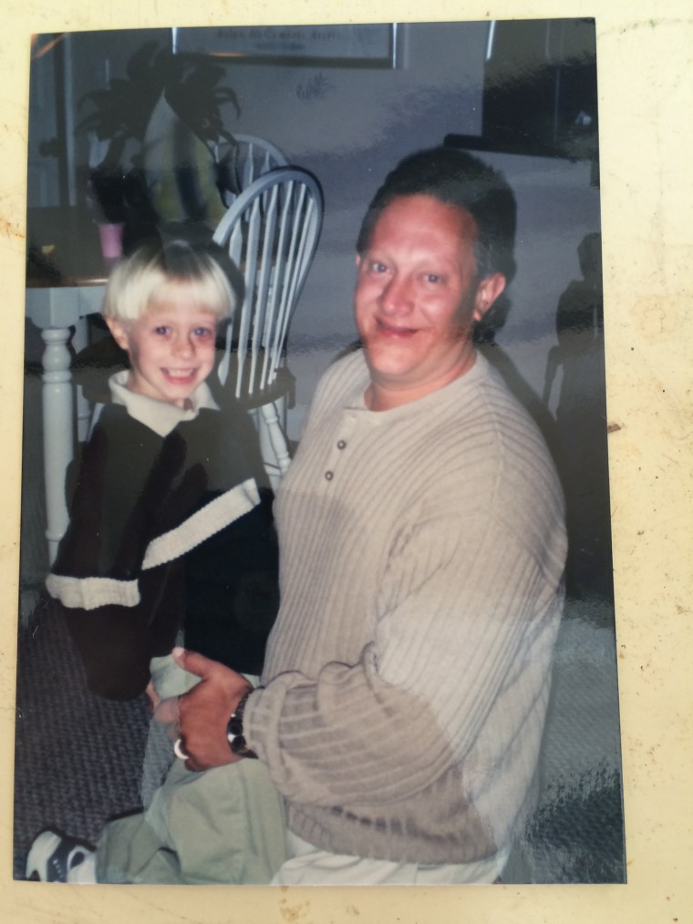 Dylann Roof is held by his father, Franklin Bennett "Ben" Roof, in a family photo.