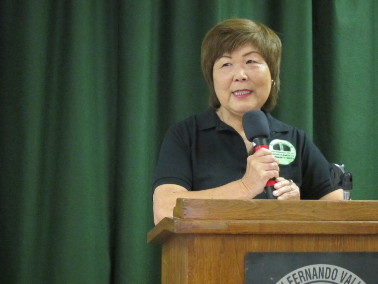 Nancy Oda standing at a podium -- exercising her activist rights and passion for Japanese American history.