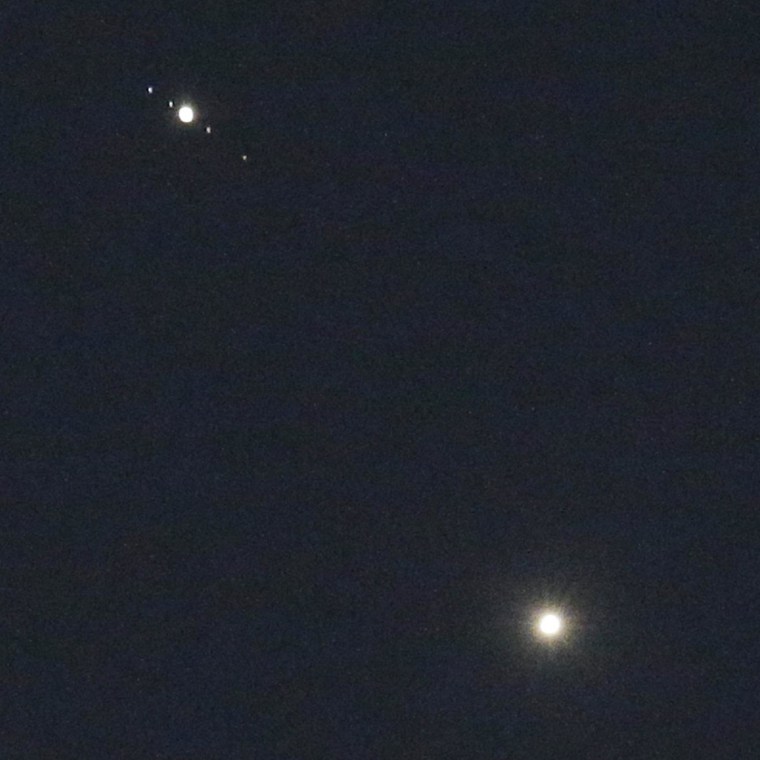 Looking at Venus and Jupiter through a good pair of binoculars should also give you a view of Jupiter's moons, seen here as pinpricks of light.