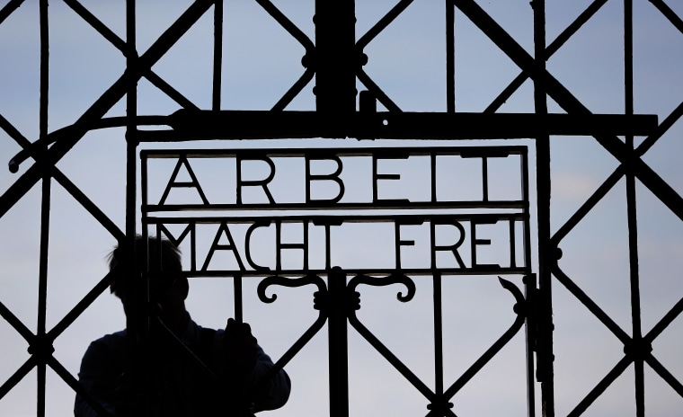 Image: A blacksmith prepares a replica of the Dachau Nazi concentration camp gate, with the writing "Arbeit macht frei" (Work Sets you Free) at the main entrance, in April 2015.