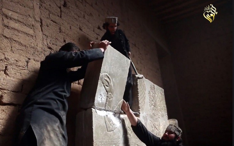 Image: ISIS members with Assyrian relief in ancient city of Nimrud, Iraq