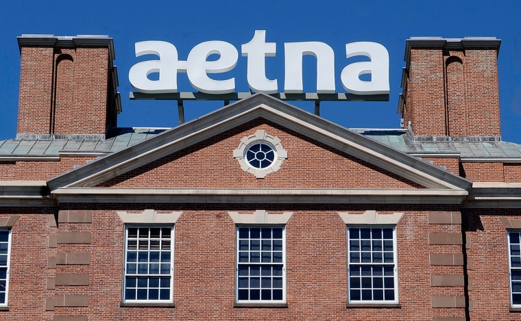 Image: A sign for Aetna Inc., sits atop a building at the company headquarters in in Hartford, Conn.