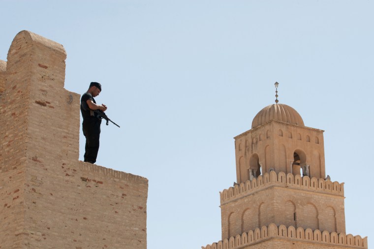 Image: A Tunisian security officer stands guard in the city of Kairouan