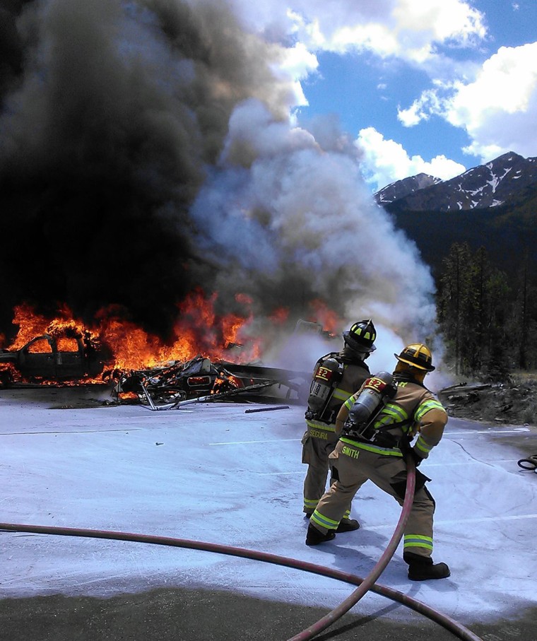 Lake Dillon Fire officials battle a fire after a medical helicopter crashed outside of a hospital in Frisco, Colorado, Friday. The pilot was killed and a paramedic and nurse were injured, officials said.